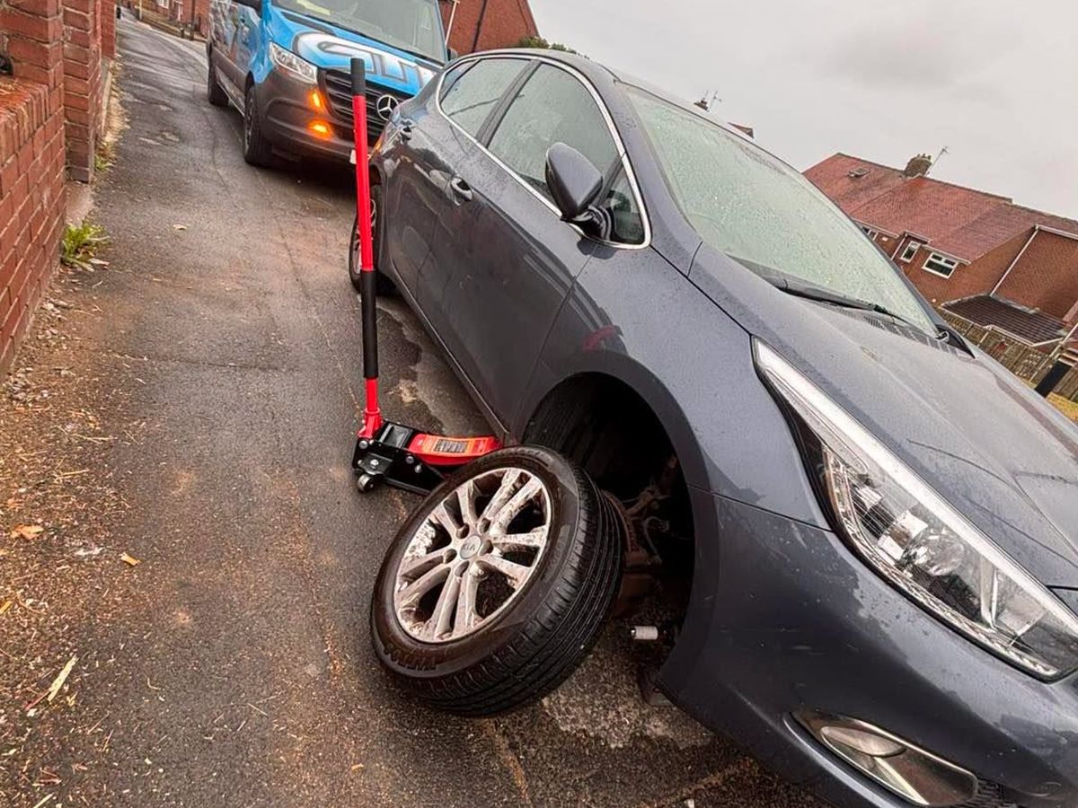 A wheel being changed at the roadside